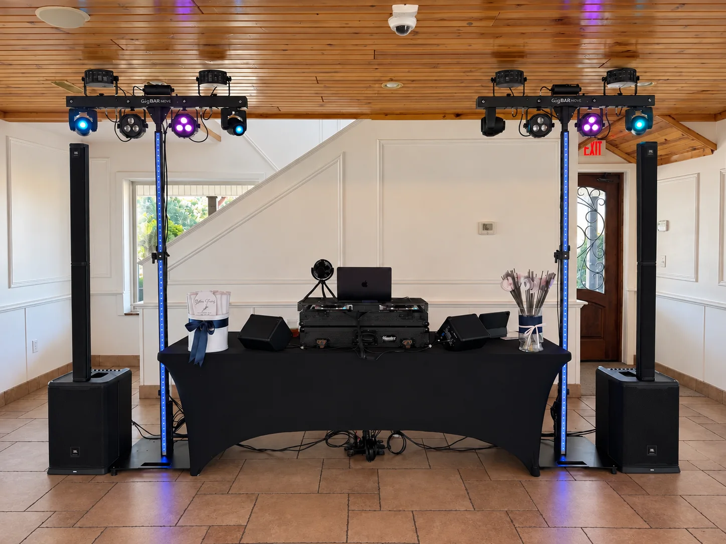 Polished BFE Productions wedding DJ setup with column speakers and coordinated lighting